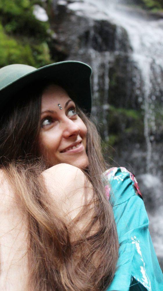Michela smiling by a waterfall