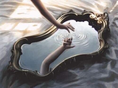 A hand reaching into the mirror's reflection