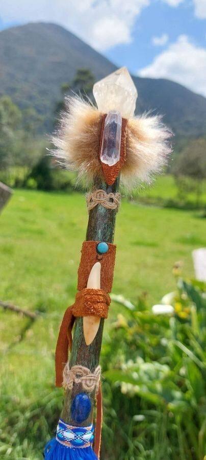 A handmade wand held to the mountains