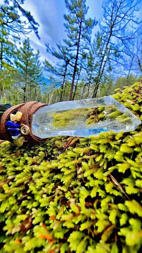 Crystal wand on moss forest